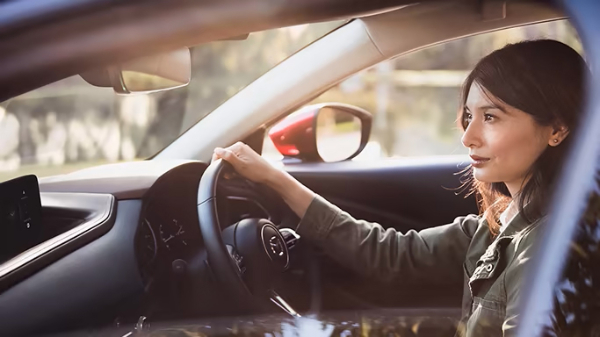 Woman focusing while driving a car.